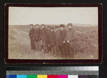 Group of eight unidentified men in field