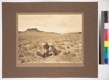 Excavating in a prehistoric Indian burial ground. Citadel ruin on hill in background. Painted Desert, Arizona
