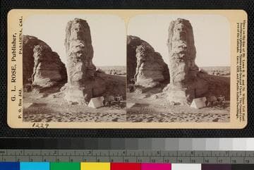 Rocky walls and camp at base of Acoma