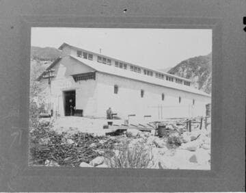 Two men standing outside of Santa Ana River #1 Hydro Plant