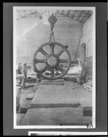A construction crew unloading the rotor in the powerhouse using an electric crane at Kern River #1 Hydro Plant