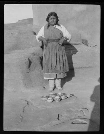 Pueblo Indian woman with pottery