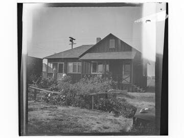 Unidentified house with two women and vegetable garden