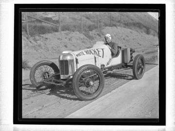 Auto racer driving "White Rocket" car, Santa Monica