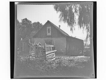 Adobe house and fenced area in yard