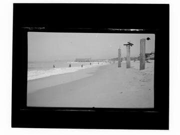 View of beach with short pier in distance, Santa Monica