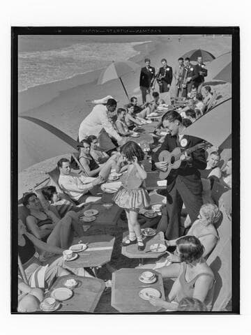 Young girl dancing on table during food service on the beach, Deauville Club in Santa Monica