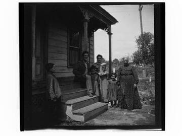 Family group on steps of house