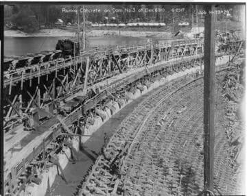 Photo shows the complex system of railroads and chuting employed to pour concrete the dams at Huntington Lake
