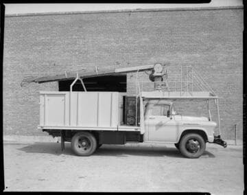Edison field truck with an extension ladder, and a dump-truck refuse bed