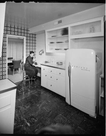 Residential kitchen with woman on phone