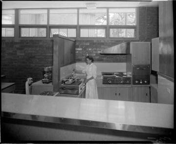 Waitress in kitchen of Cafe