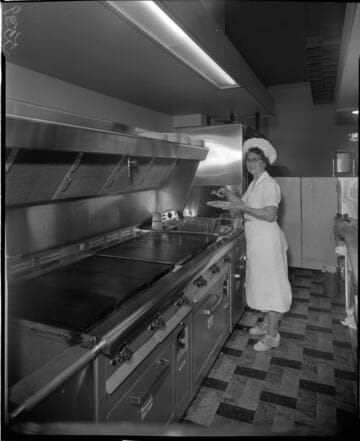 Chef serving fries in kitchen
