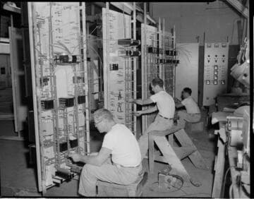 Men assembling panels at control center