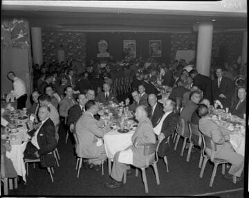 People at tables during speeches