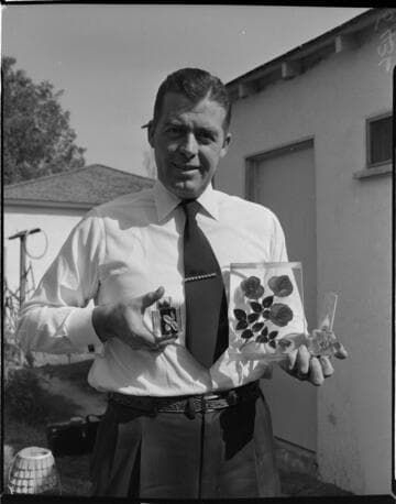 Man holding flowers embedded in clear plastic