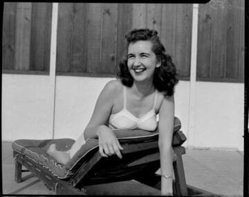 Young lady in 50s bikini on sun lounge