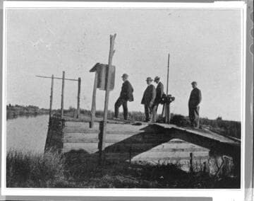 Four men at a canal intake