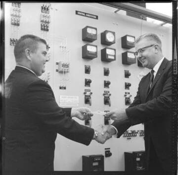 Men receiving certificates of completion for control room training