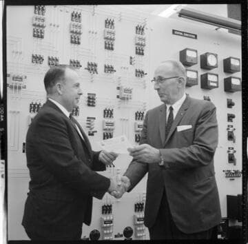 Men receiving certificates of completion for control room training