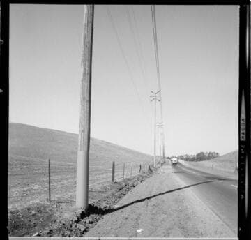 Double-circuit transmission poles corridor along a rural road