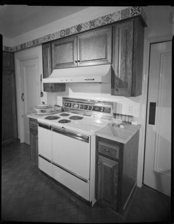 Electric range built into an older remodeled kitchen