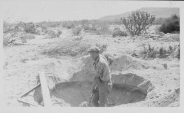 Series of 3 shots copied from a photo album page of men digging in rocky desert soil to place a power pole