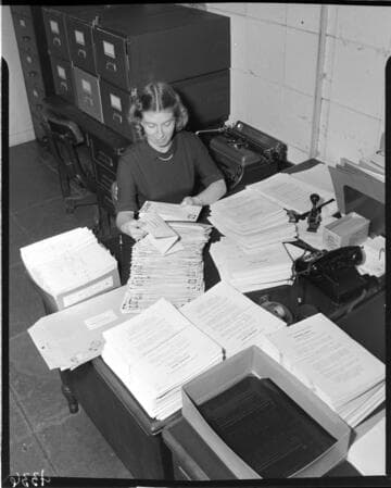 Lady receiving and tabulating Personnel Survey forms