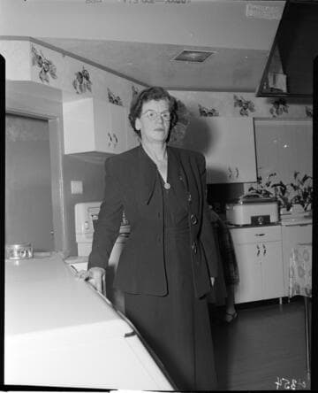 Woman standing in model kitchen