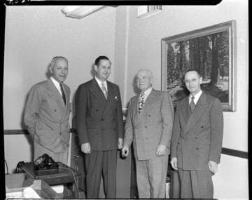 Four men in suits
