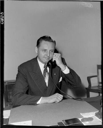 Man at desk on phone