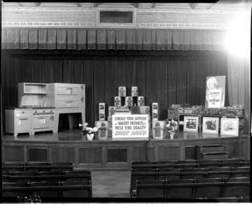 Display of commercial restaurant cooking equipment and food products on the stage the G.O. auditorium