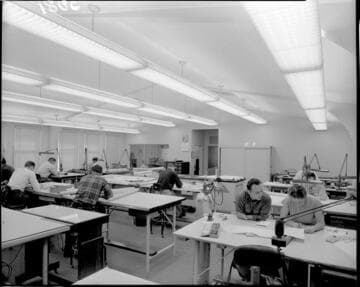 People working in a drafting room