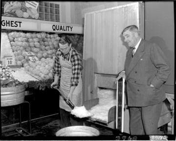 Grocer (Jack Wray) working with produce