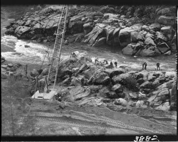 Men doing excavation at waters edge for Powerhouse #4