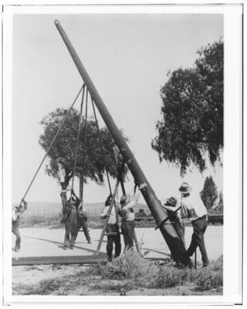 Raising a power pole using gin-poles and lots of muscle, during construction of the line to Perris, 1912