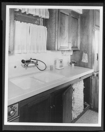 Under-counter electric water heaters with insulation covers in all-electric kitchens