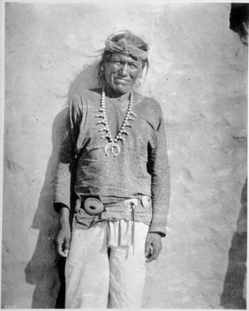 Navajo; a "friendly" with a solid silver neck ornament and belt
