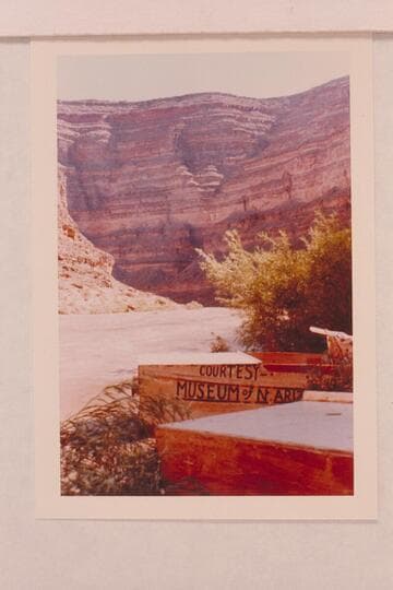 Jack Frost punts for San Juan trip of 1958, June. The painted sign was to facilitate clearing the Glen Canyon Dam site in 1957