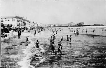 Long Beach shore with bathers showing pier, June 28, 1925