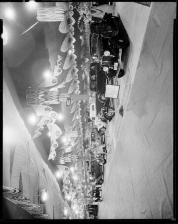 REO automobiles at an auto show. 1934