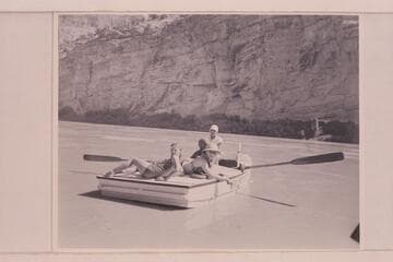 Nevills at the oars of the "WEN" in the lower end of Horseshoe Canyon. Joan Nevills and Ros Johnson are on the stern while Al Milotte sits forward. Note the "windmill recovery" of the oars characteristic of the Nevills technic