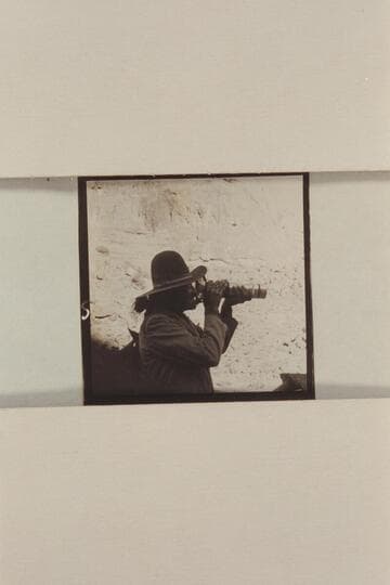 Buck White-hat, Navajo Indian guide. Ch'ahlgaii. Finding the white man's aid to sight can be amusing