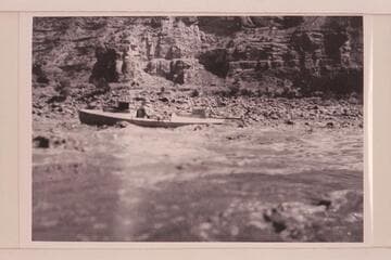 Loper in a rapid.  USGS survey trip from Green River, Wyoming, to Green River, Utah.  Note the boxes on the hatch covers which were seats for Woolley and Trimble in the fashion of Powell