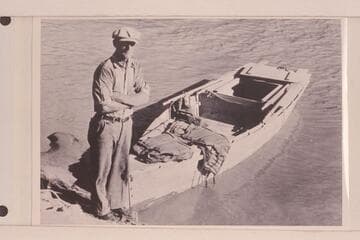 Merrill F. Spencer with his skiff, the "Ethel" in which he made the run from Lees Ferry to Bright Angel Creek in 1934, Oct