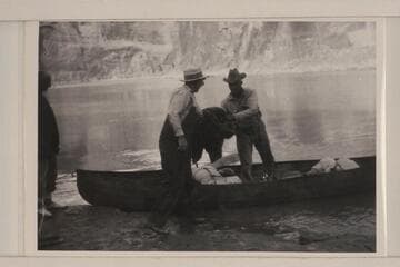 Loading one of Dave Rust's folding canvas boats; Glen Canyon. Bert Loper is at left