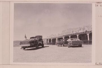 The "Step In Again" on the trailer at left and the "Twin" on the truck. The "June Bug" on the trailer at right and Art Greene's "Cliff Dweller's Lodge"