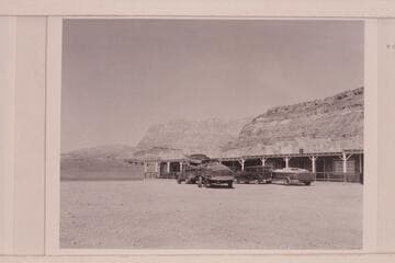 The "Step In Again" on the trailer at left and the "Twin" on the truck. The "June Bug" on the trailer at right and Art Greene's "Cliff Dweller's Lodge"