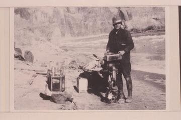 Pat Flattum and the Indian motor used in Glen Canyon trip. Note the dangerous "authority boots" and the choke-bored breeches