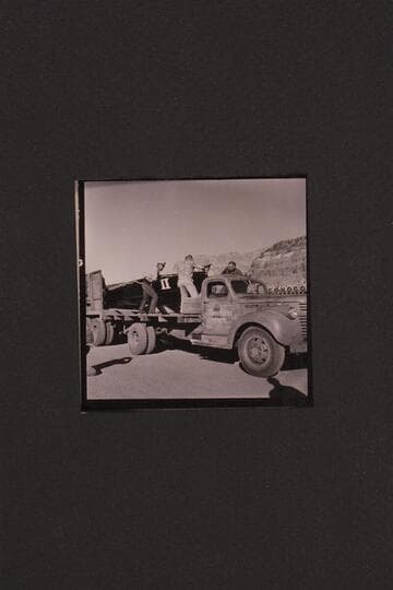 Unloading boats at Cliff Dweller's Lodge. Rod Sanderson, Dick Rose, Vern ? and Bill Belknap move boat onto truck from the trailer